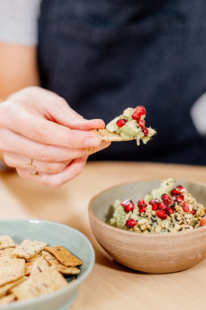 guacamole dip with pomegranate and savoury granola
